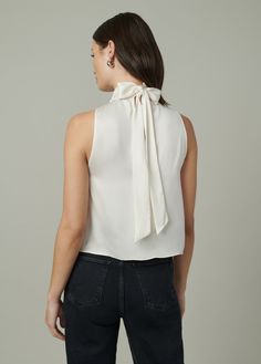 Sleeveless, high neck top with shirred neckline and back scarf tie for versatile styling. DETAILS + FIT High neckline Sleeveless Shirred scarf tie Back keyhole opening Silky satin with the perfect drape. 100% PolyesterMoa is 5’10” and is wearing a size Small Waist: 25” Bust: 33” Hips: 35.5” Elegant Sleeveless Halter Top With Tie Back, Elegant Sleeveless Tie-back Halter Top, Elegant Silk Halter Top For Formal Occasions, Elegant Silk Halter Top For Formal Events, Elegant Halter Neck Top With Tie Back, Elegant Satin Halter Neck Top, Elegant Sleeveless Tie Back Blouse, Elegant Sleeveless Tie-back Blouse, Elegant High Neck Silk Top