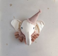 an elephant head with a pink tutu skirt on it's side and a star in the background