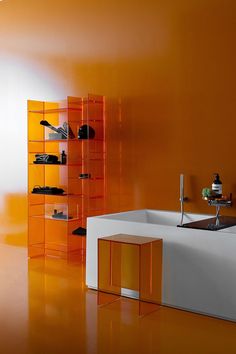 a modern bathroom with orange walls and white furniture