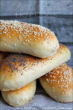 four sesame seed bagels stacked on top of each other