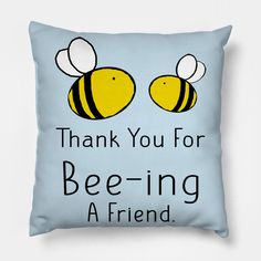 a blue pillow with two bees and the words thank you for bee - ing a friend