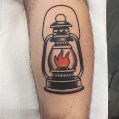 a tattoo on the arm of a man with a fire in a light bulb inside it