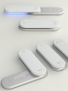 four electronic devices are shown with blue light coming out of the top and bottom ones