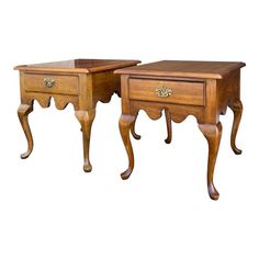 two wooden tables with drawers on each side