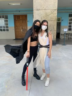 two women dressed up as darth vader and princess leia pose for the camera