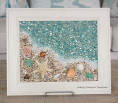 an ocean scene with starfish, shells and other sea creatures is displayed in a white frame