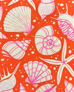 an orange background with pink and white seashells on red paper in the center