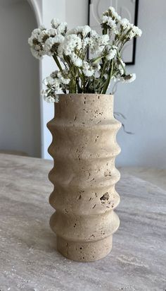 a vase with flowers in it sitting on a table