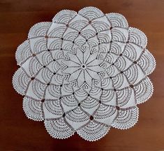 a white doily on a wooden table