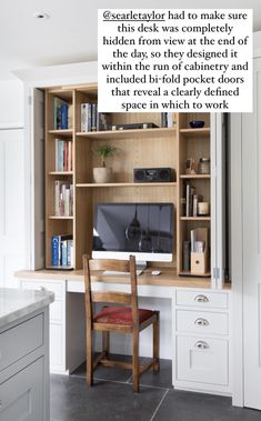 a desk with a computer on top of it in front of a book shelf filled with books