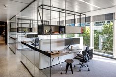 an office with glass walls and desks