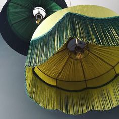 two green and yellow umbrellas hanging from the ceiling