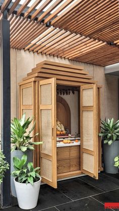 an outdoor kitchen with potted plants in it