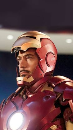 the iron man is standing with his head turned to look like he's holding a light