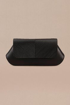 Black clutch in faux leather base with corded flap.
Composition: 100% PU/Faux Leather
Color: Black
Other Details: 
Dimensions (in inches): L x W x D: 10 x 1.8 x 4.5
 - Aza Fashions Black Leather Pouch Clutch, Black Leather-lined Pouch Clutch, Modern Black Clutch In Soft Leather, Black Leather Clutch With Leather Lining, Black Clutch With Leather Lining For Formal Occasions, Black Structured Soft Leather Bag, Formal Black Clutch With Leather Lining, Modern Black Soft Leather Clutch, Sleek Leather Rectangular Clutch