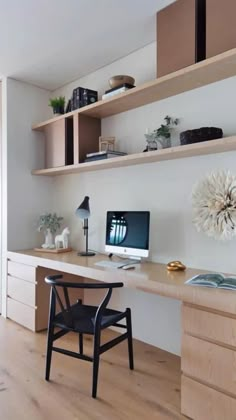 a desk with a computer on top of it and shelves above the desk in front of it