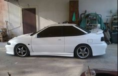 a white car is parked in a garage