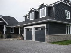 a large house with two garages on each side