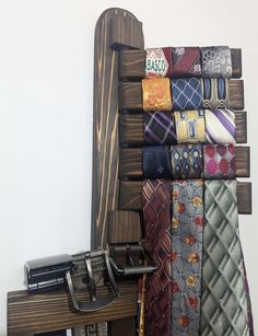 a bunch of ties that are hanging on a wall in front of a typewriter