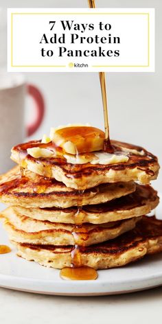 pancakes stacked on top of each other with syrup being drizzled over them