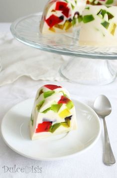 a slice of cake on a plate with a fork next to it and another piece in the background