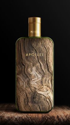 a bottle of perfume sitting on top of a wooden table next to a black background