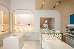 a woman is working in a pastry shop