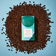 a bag of coffee beans sitting on top of a blue surface