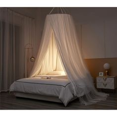 a bed with a white canopy over it