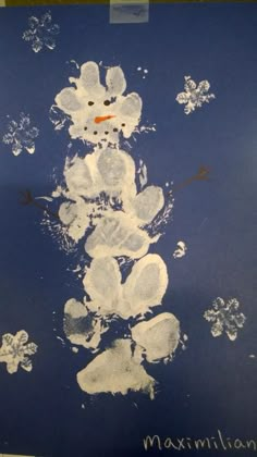 a snowman made out of white paper on a blue background