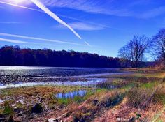 the sun shines brightly over an empty lake