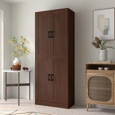 a brown cabinet sitting next to a white table