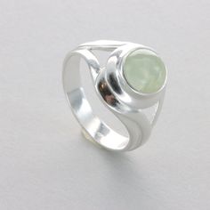 These is a beautiful Sterling Silver Ring with a Prehnite Gemstone from South Africa. The ring is made out of solid 925 Silver and there is no nickel or other substances causing most allergies. This makes the ring hypo allergenic. Size of the Prehnite 0.8 x 0.8 cm or  0.31 x 0.31 inch Please note: Our jewelry is photographed close up to show detail and may appear larger than they are. We use a dime coin as size reference on one of the pictures. You will receive the item in a gift box - perfect t Handcrafted Artisan Jewelry, Allergies, Artisan Jewelry, Rings Statement, 925 Silver, Natural Gemstones, Statement Rings, Sterling Silver Rings, Jewelry Watches