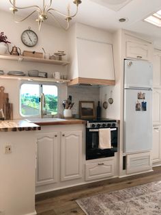 a kitchen with an oven, sink and refrigerator