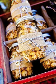 a bunch of jars filled with food sitting on top of a table