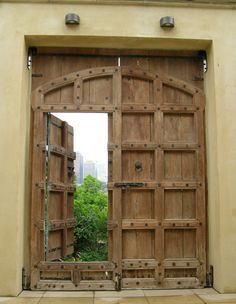 an open wooden door on the side of a building