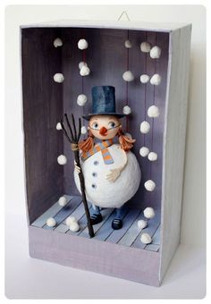 a snowman in a box with skis and poles