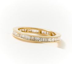 a gold ring with baguetts of diamonds