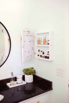 a bathroom sink with a mirror above it and shelves on the wall behind it that are filled with personal care items