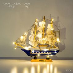 a model ship with lights on it sitting on a table