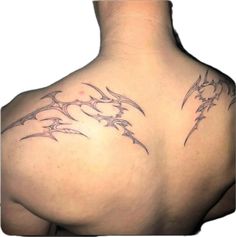 the back of a woman's shoulder with tattoos on it