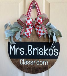 a door hanger that says mrs brisko's classroom hangs on the front door