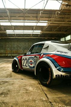 an old race car is parked in the garage