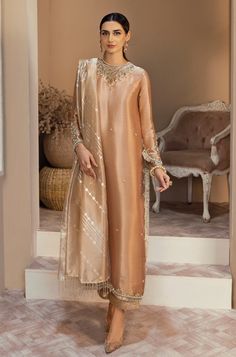 Bahaar, the pink pure tissue ensemble is a classic long shirt handworked with kora, dabka, sequins and pearls in shades of gold and silver. The shirt comes with a long detailed back with cutdana tassels and a matching izaar pant. The dupatta comes in a contrast pink peach color with foil printing and dangly tassels on Mehndi Beautiful, Indian Formal Wear, Embroidery Embellishments, Indo Western Gown, Traditional Suit, Foil Printing, Pakistani Party Wear, Bridal Lehenga Red