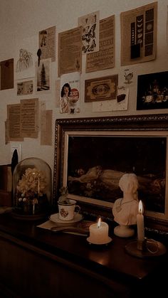 a table with candles and pictures on the wall next to an old fashioned dresser in a living room