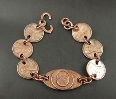 Handmade, One of a Kind, Copper Penny Bracelet with Center Oval  Raised Lincoln Penny, 6 Penny Links with dates 1973,76, 77, 81, 74, 75. Bracelet  is  8  inch long and made with Heavy Gauge Round Jump Rings. The Clasp on this 8 inch bracelet is a solid Copper Sister Hook. 8 inch, with Penny Links, Heavy Copper Jump Rings, Center is a raised Lincoln Penny on Oval, Clasp Copper Sister Hook. Some use copper Arthritis Pain. Please remember this is copper and will discolor skin which can be removed e Penny Jewelry, Penny Bracelet, Copper Penny, American Coins, Skin Discoloration, Coin Jewelry, Enamel Jewelry, Copper Jewelry, Remember This