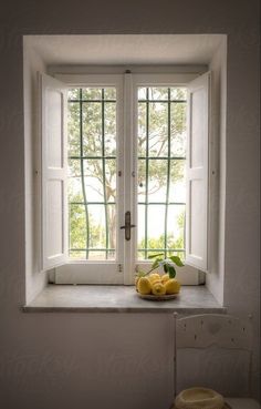 two lemons are sitting on the window sill in front of an open door