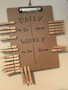 a clipboard with clothes pins attached to it that says daily to do, done weekly to do one