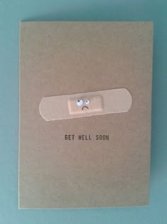 a card with a button on it that says get well soon in front of a blue background