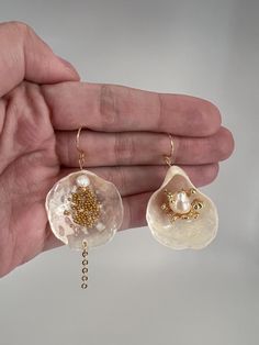 All seashell earrings are hypoallergenic and handmade. This pair features natural seashells, "caviar" balls, and 18K gold-plated findings.    🐚Natural seashells from the ocean 🌊  ✨ Non-tarnish, hypoallergenic gold-plated findings  👂Great for sensitive ears 💛Nickel and lead-free 🫶🏼Crafted slowly and with love - Our Products - We work with high-quality, natural materials that stand the test of time. Since each piece is handmade with natural materials such as freshwater pearls, stone beads, a Seashell Earrings, Pearl Dangle Earrings, Earrings Unique, Shell Jewelry, Pearl Earrings Dangle, Unique Gifts For Her, Shell Earrings, Unique Earrings, Gold Plated Jewelry